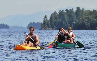 canoe – Long Lake Camp For The Arts Campers kayaking and enjoying the calm lake water.