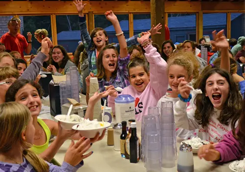 icecream – Long Lake Camp For The Arts Campers laughing and enjoying a meal in the dining hall.