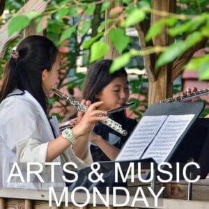 Students playing instruments in the arts and music session.