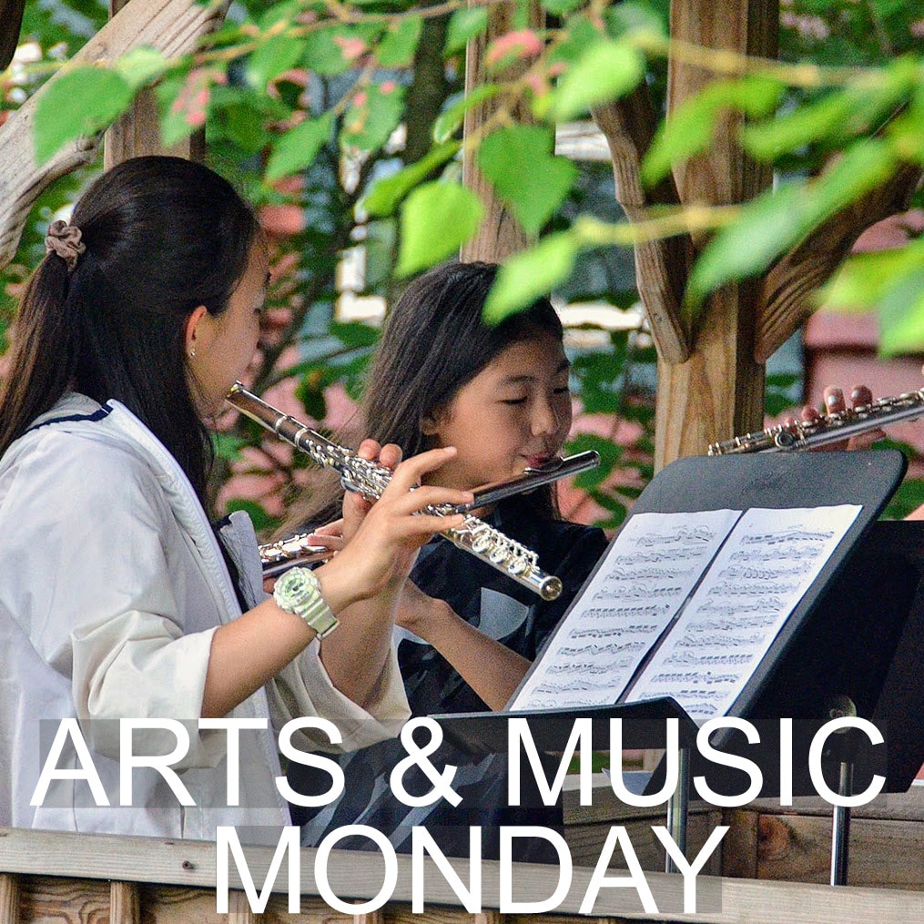 Students playing instruments in the arts and music session.