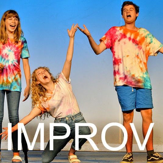 Participants laughing during an improv workshop.