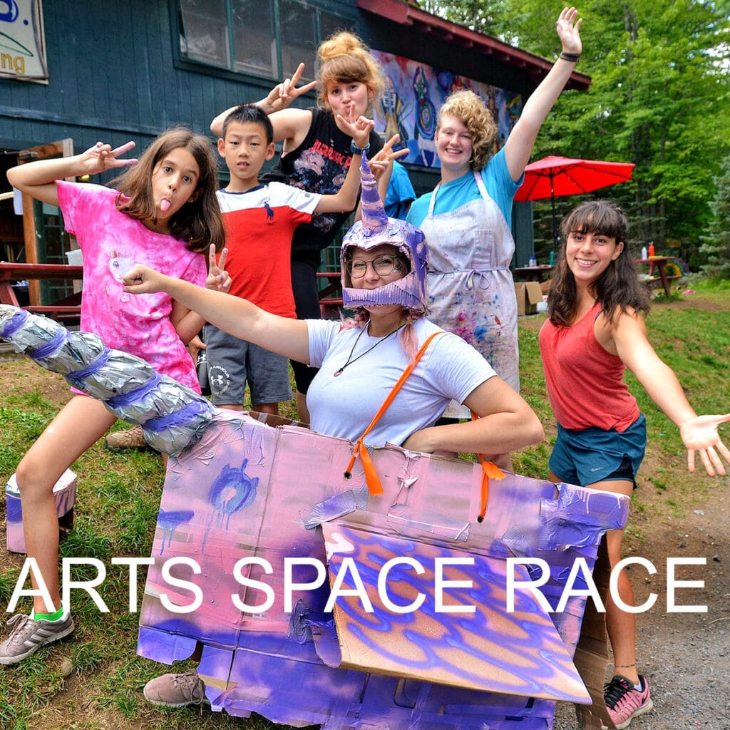 Campers racing in colorful arts space activity.