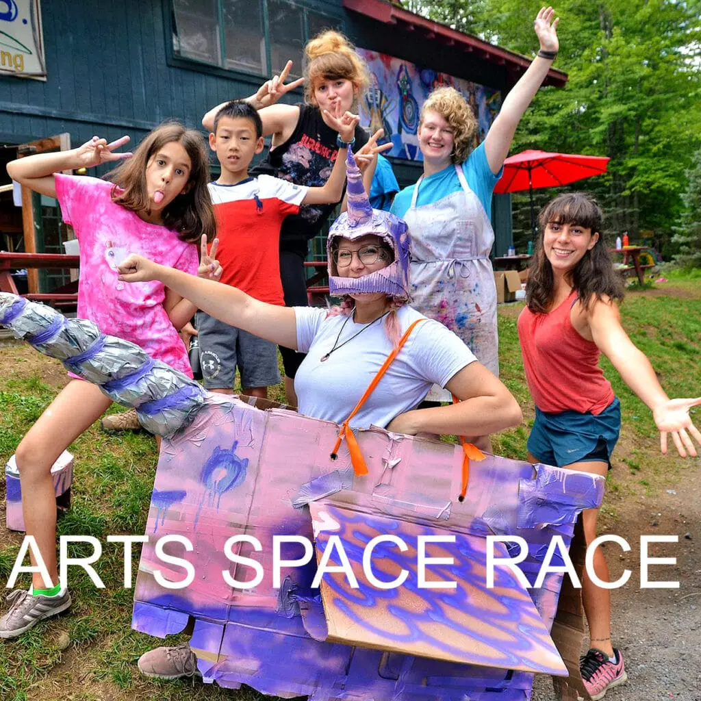 Campers racing in colorful arts space activity.