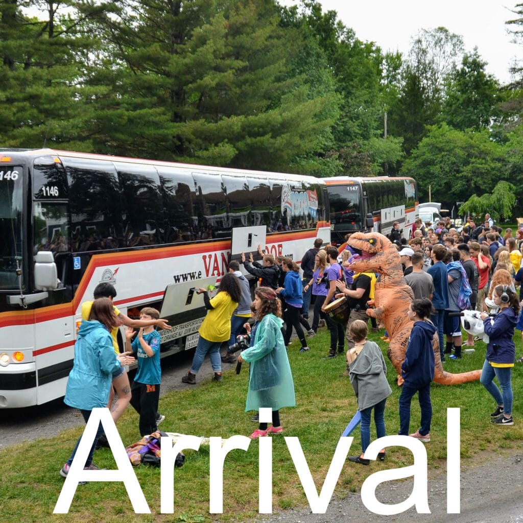 Campers arriving at Long Lake Camp as buses pull in