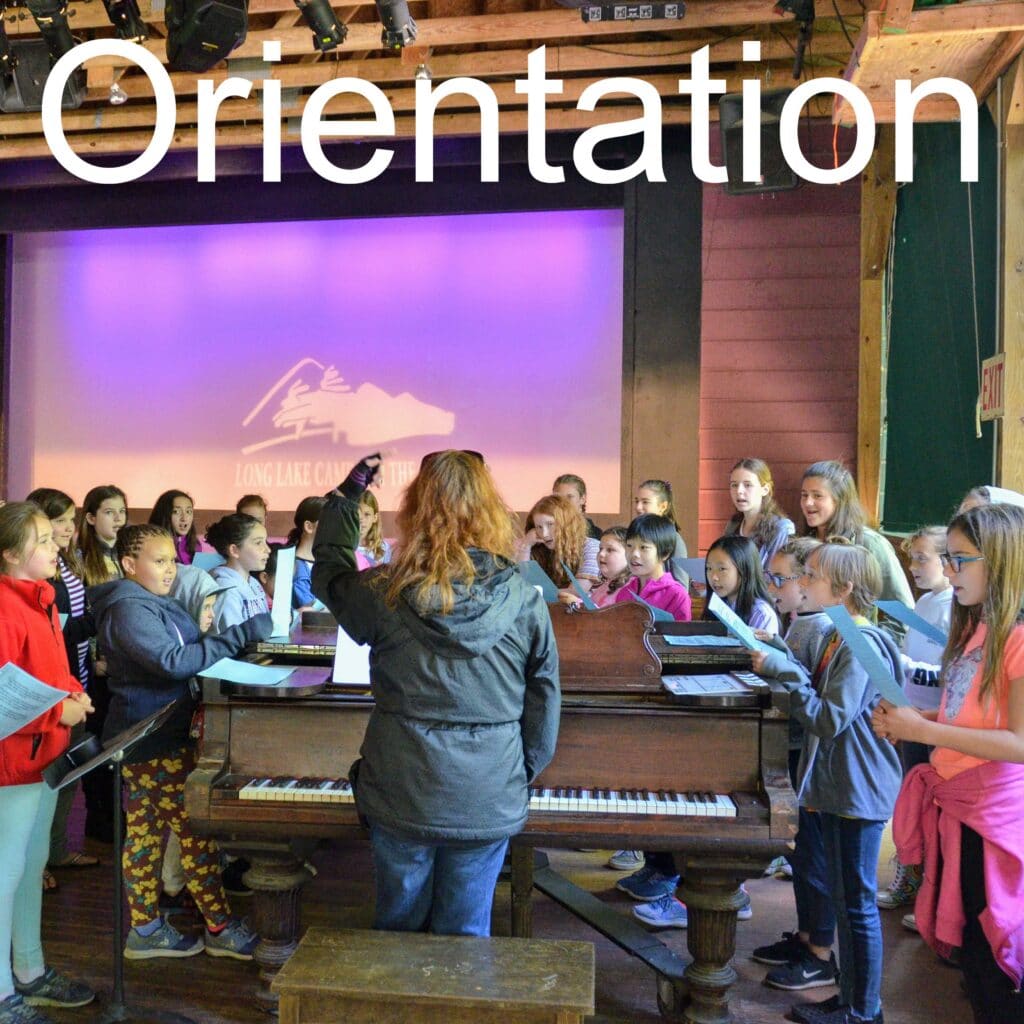 Orientation session with campers singing at Long Lake Camp.