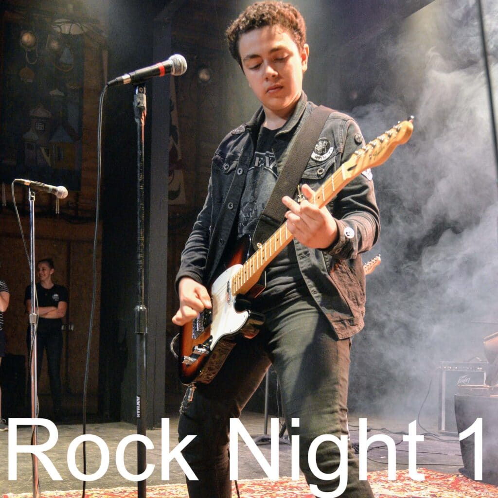 Teen musicians playing on stage during Rock Night at Long Lake Camp.