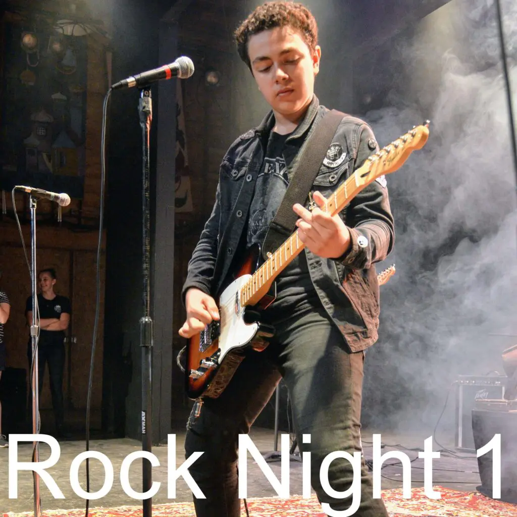 Teen musicians playing on stage during Rock Night at Long Lake Camp.