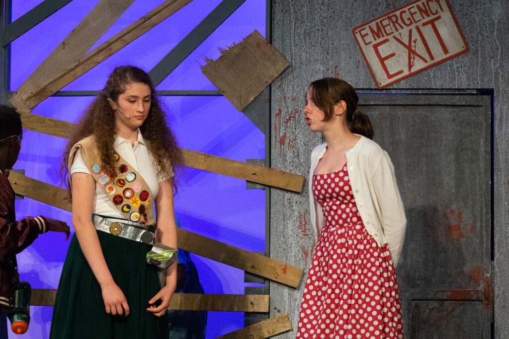 Campers performing a scene onstage during a theater production.