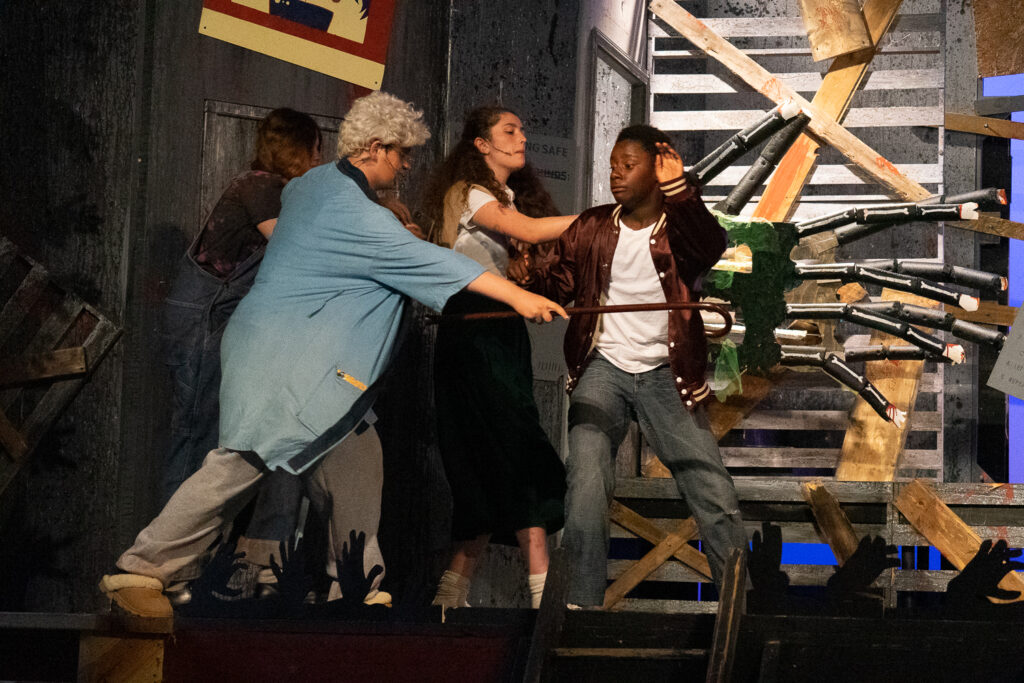 Zombie-themed youth stage performance at summer camp.