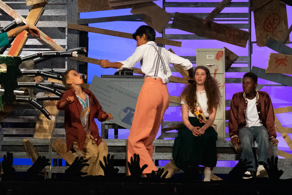 Zombie-themed youth stage performance at summer camp.