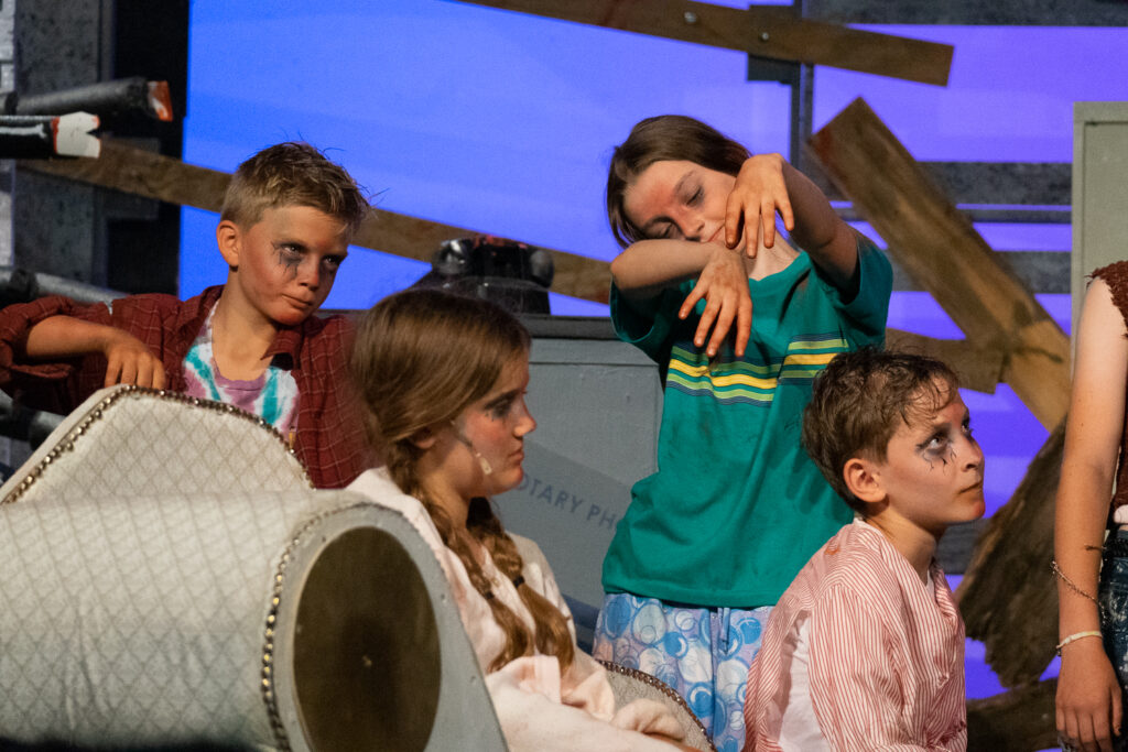 Zombie-themed youth stage performance at summer camp.
