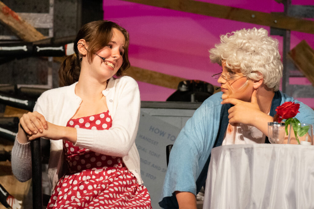 campers performing a dramatic scene onstage during a theater camp production.