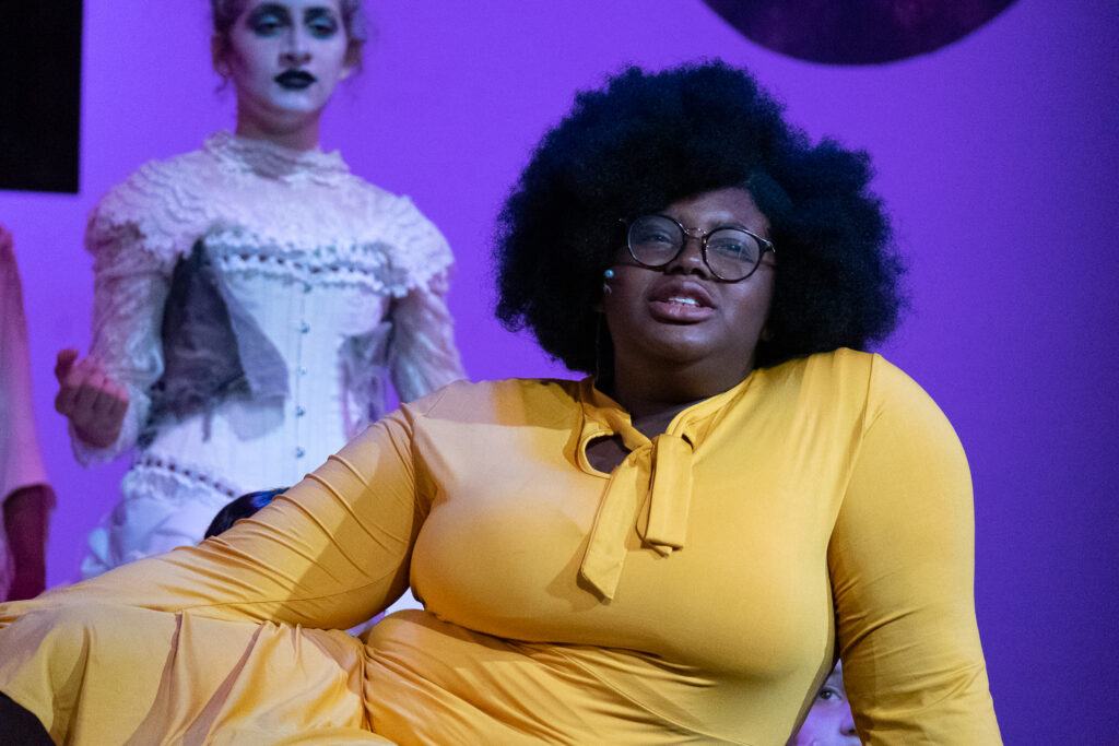 Two performers onstage during an Addams Family theater production.