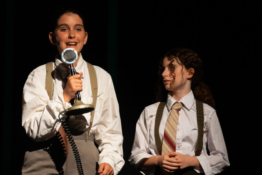 Long Lake Camp for the Arts campers in a dramatic Annie scene