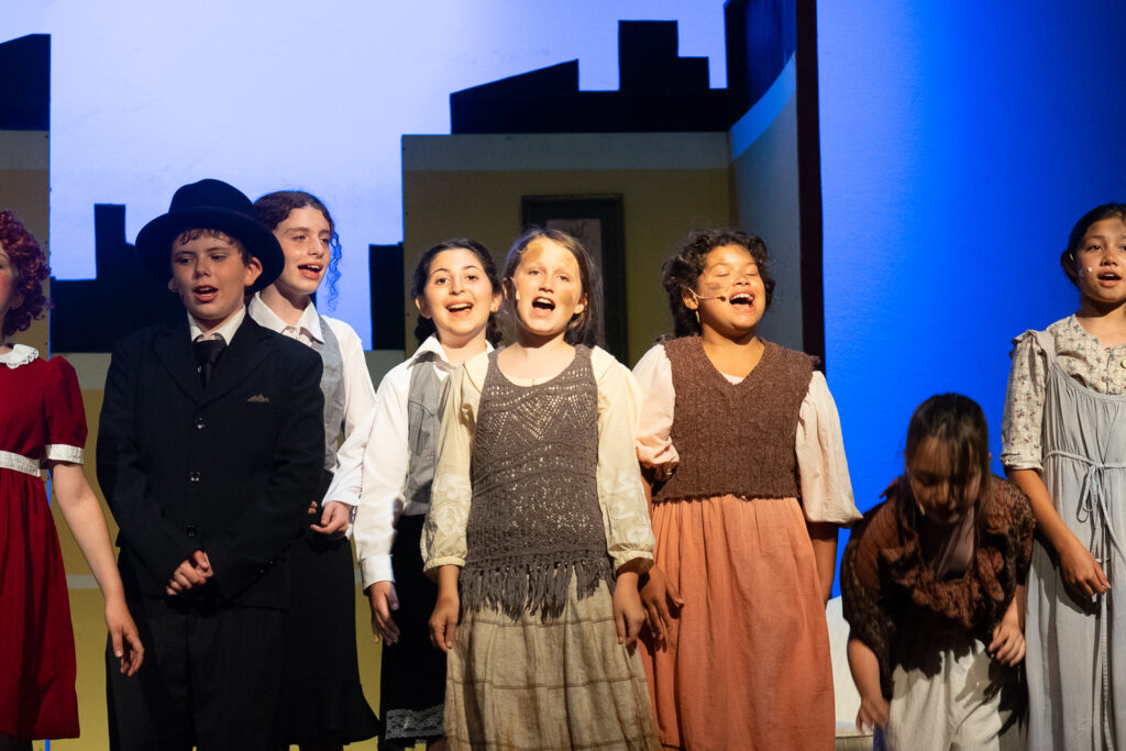 Long Lake Camp for the Arts youth performing an Annie scene