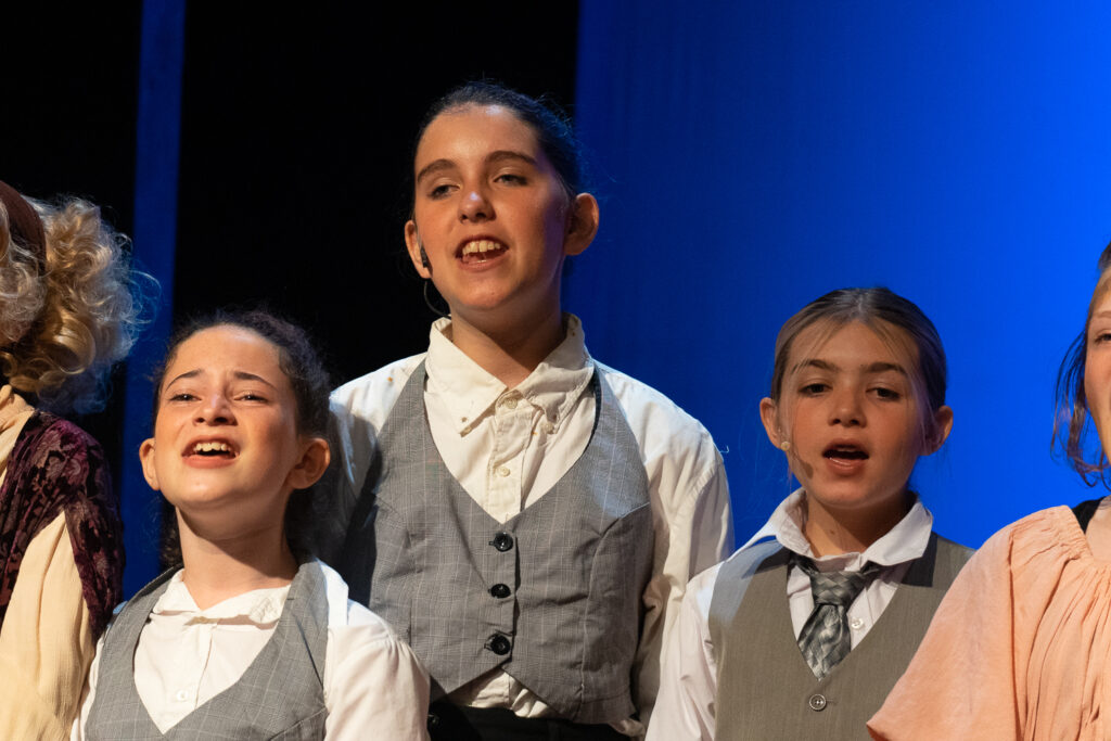 Long Lake Camp for the Arts youth performing an Annie scene