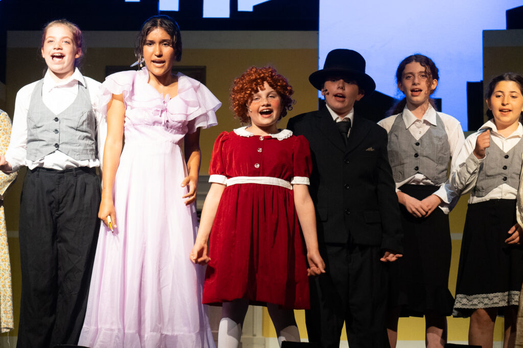 Long Lake Camp for the Arts drama campers portraying Annie characters