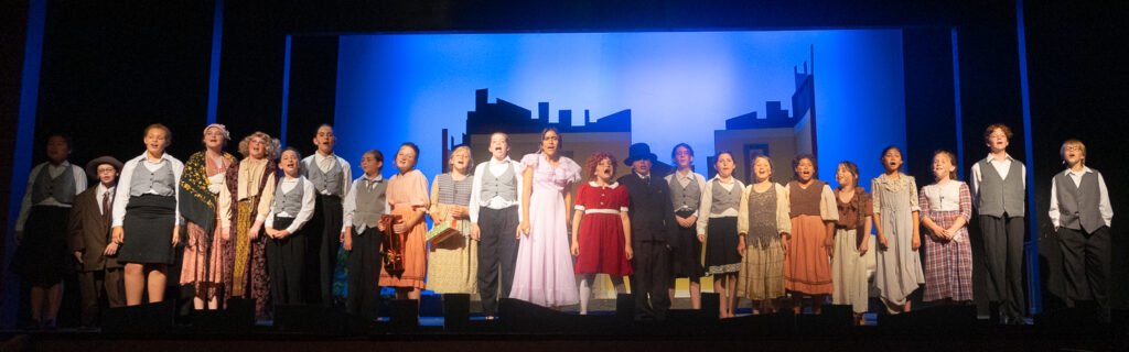 Annie stage scene by young actors at Long Lake Camp for the Arts