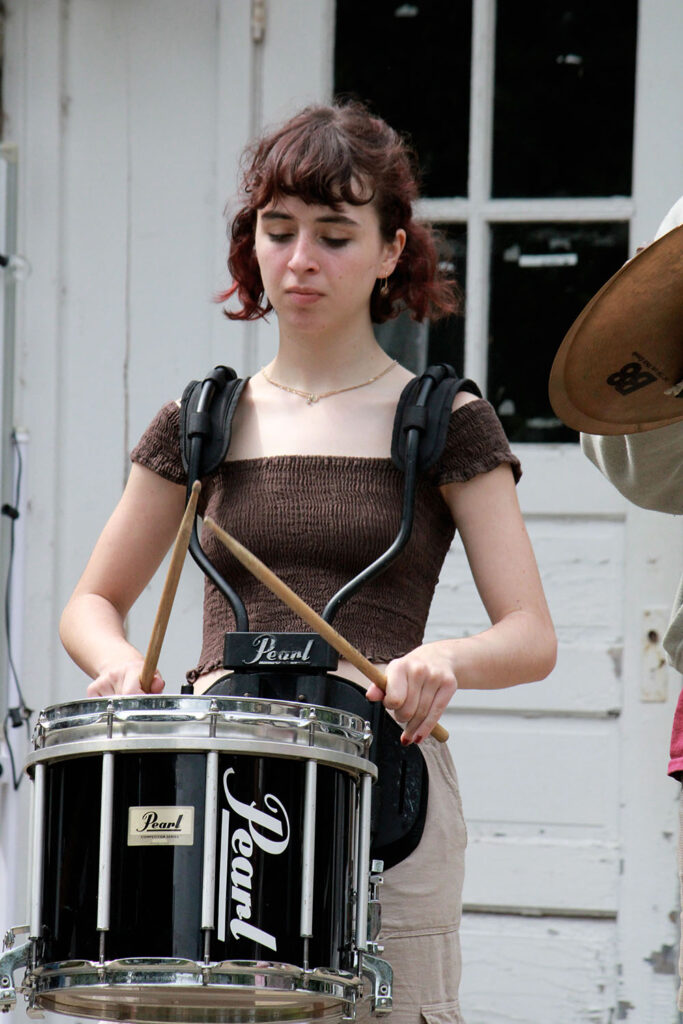 Music camper rehearsing snare drum techniques