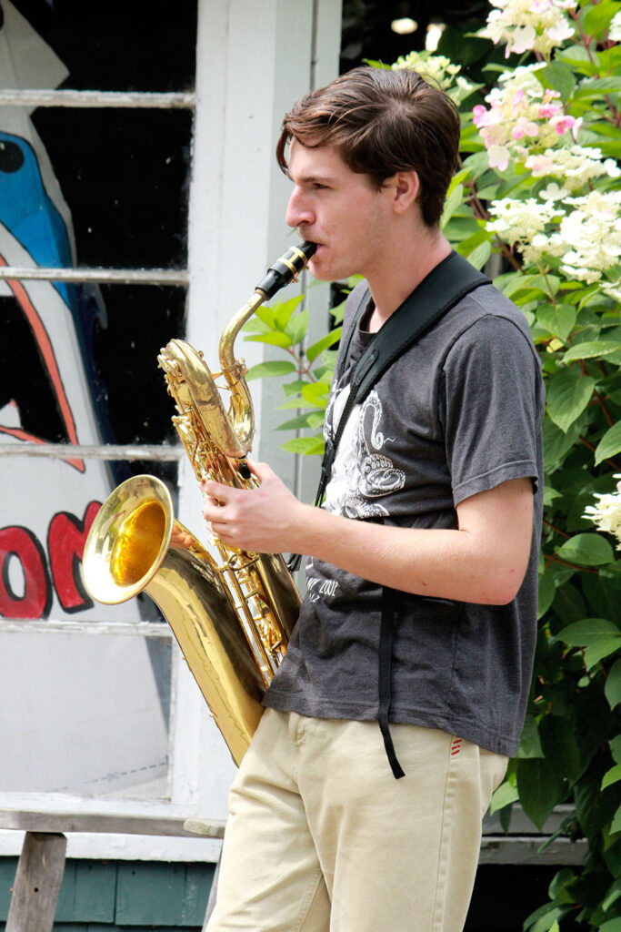 Saxophone player practicing during outdoor camp rehearsal