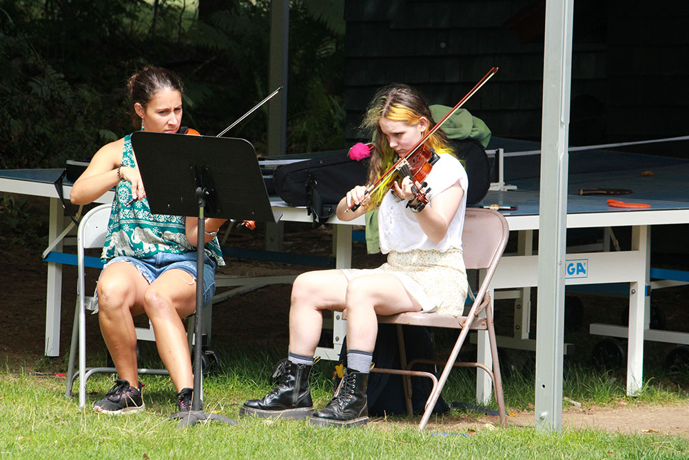 String musicians practicing together during camp rehearsal
