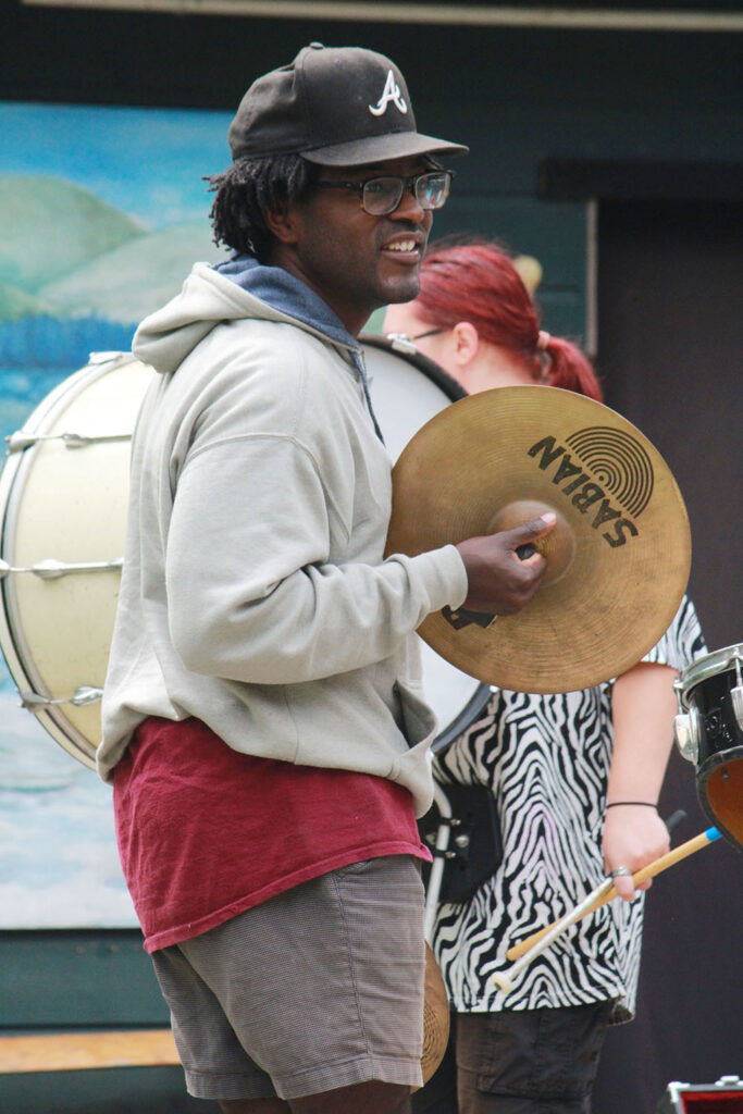 Percussionist rehearsing with cymbals during extravaganza practice at Long Lake Camp