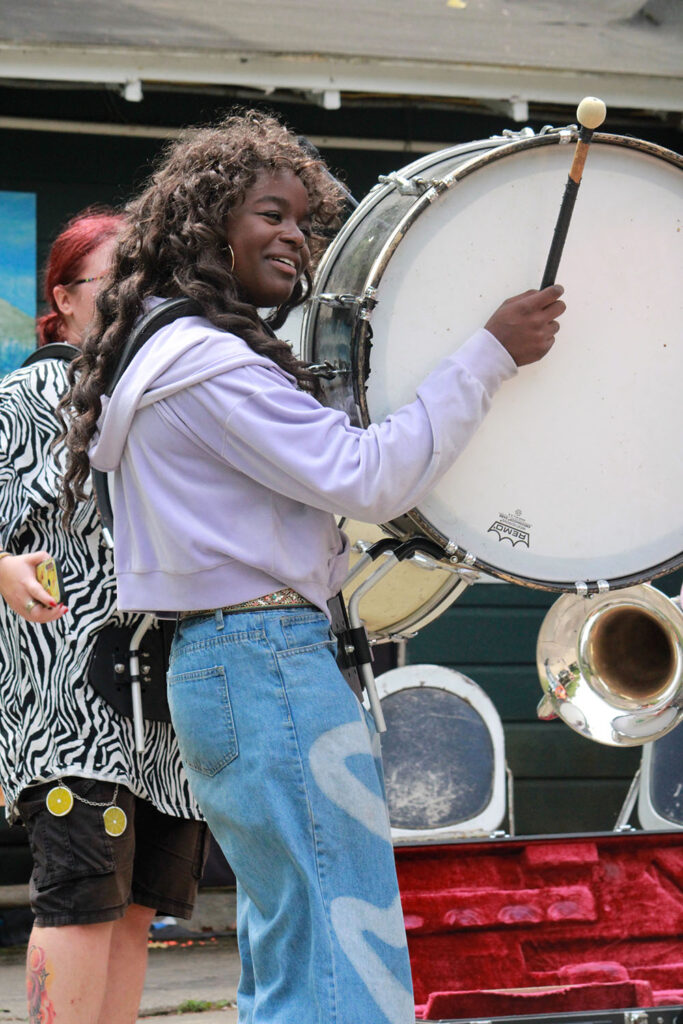 Camper practicing bass drum performance during extravaganza rehearsal