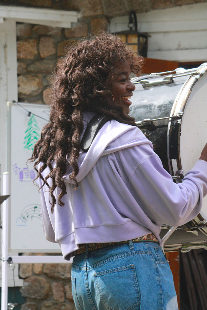 Percussion rehearsal with campers playing large drum at Long Lake Camp