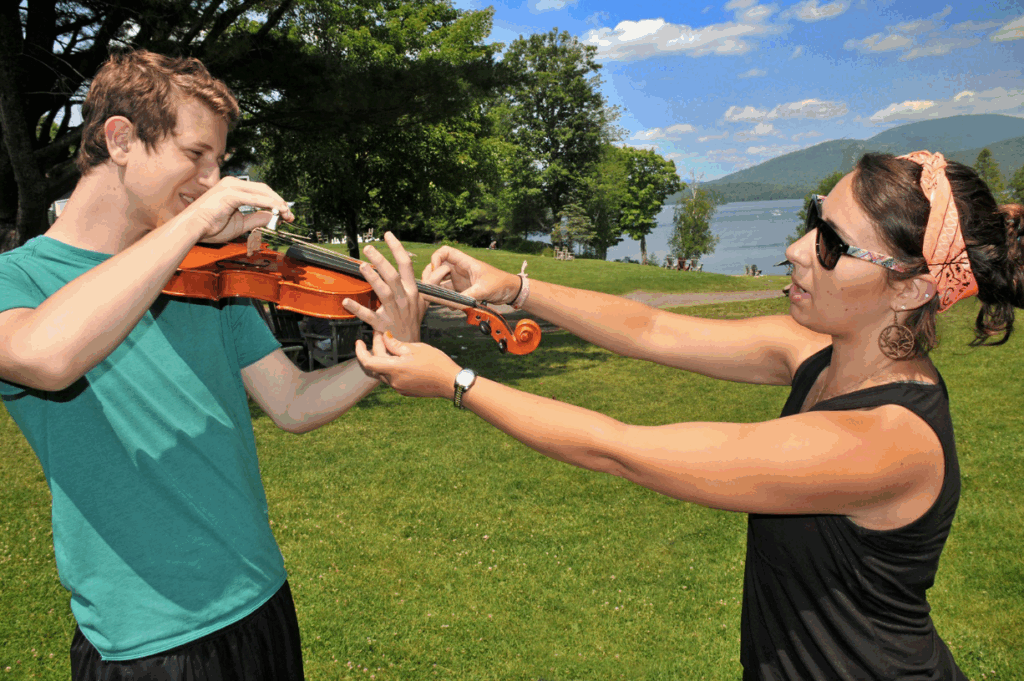 music-camp-ukulele-lesson – Long Lake Camp For The Arts Music teacher guiding a camper through a lesson at Long Lake Camp