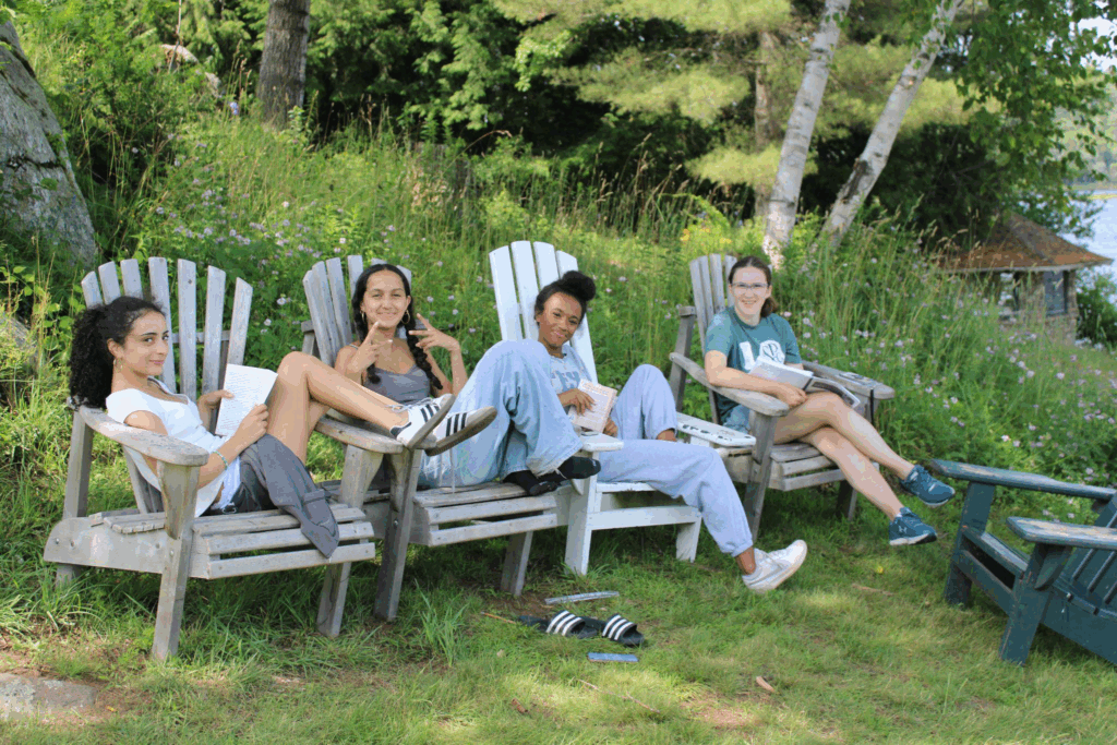 teens-relaxing-friendships-summer-camp – Long Lake Camp For The Arts Group of teens sitting together at camp, enjoying new friendships and the freedom of summer