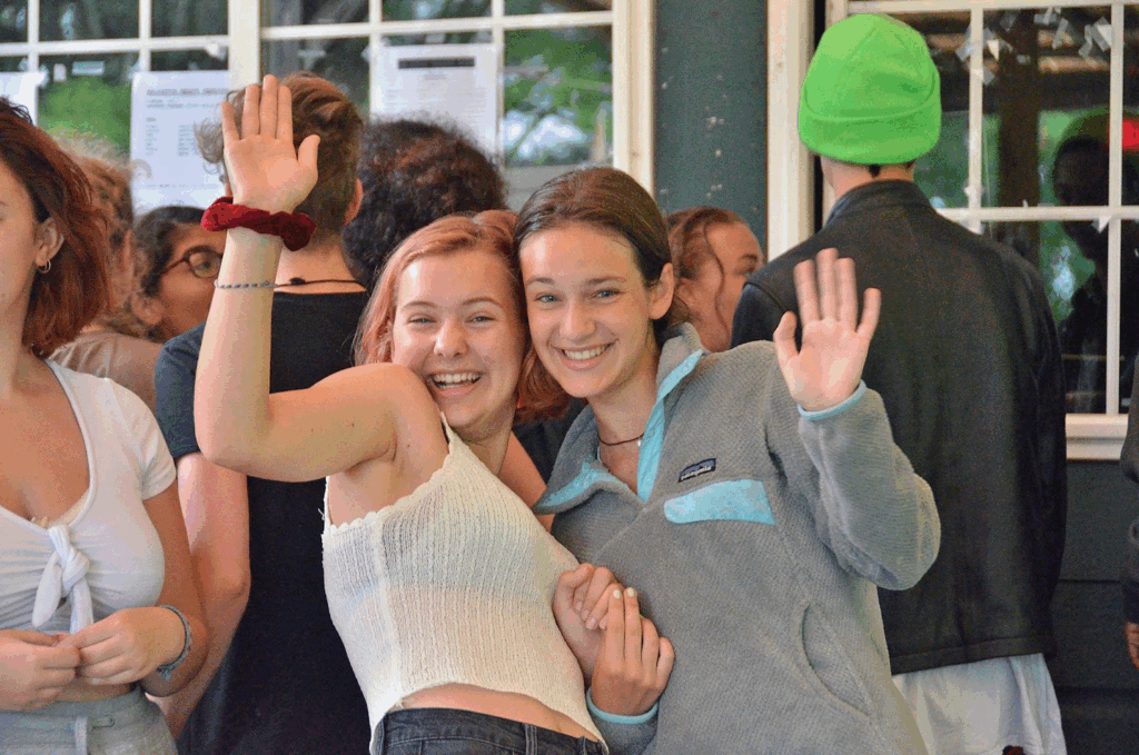 girls-waving-at-camp – Long Lake Camp For The Arts Two girls smiling and waving.