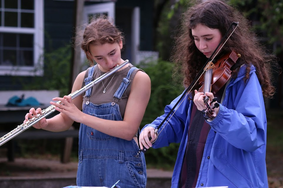 teen-girls-sharing-music-bond – Long Lake Camp For The Arts Two teen girls playing instruments and sharing a friendship through music