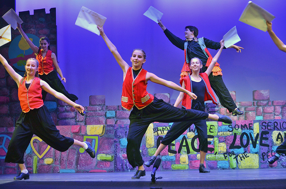 teens-dance-performance-costume-stage – Long Lake Camp For The Arts Teens performing a high-energy dance routine in costume during a performing arts show.