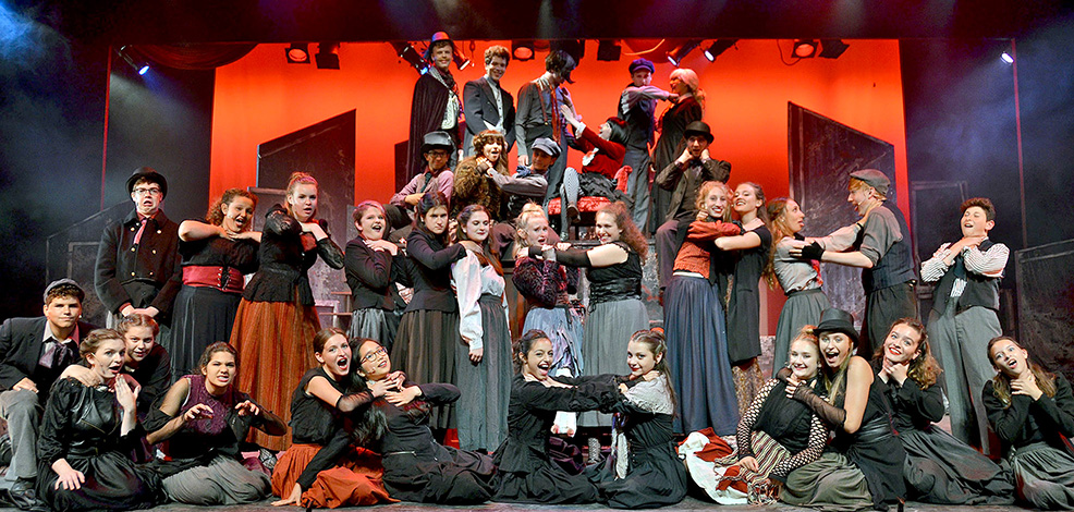 weeney-todd-cast-stage-performance-long-lake – Long Lake Camp For The Arts Full cast of Sweeney Todd standing confidently on stage in full costume during a Long Lake Camp production