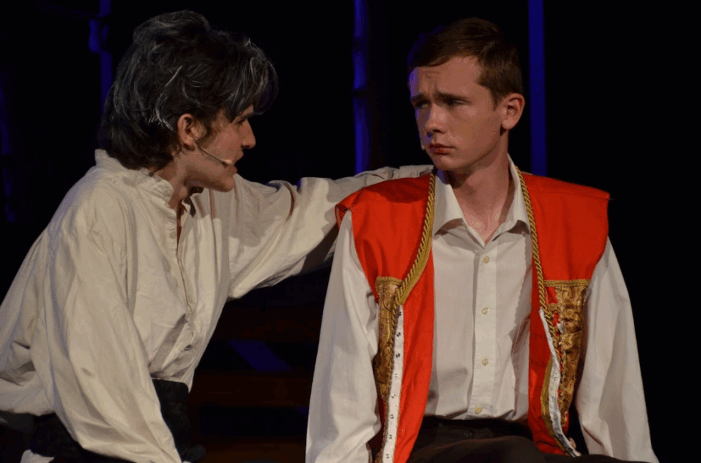 teen-boy-les-miserables-role-performing-arts-camp – Long Lake Camp For The Arts A teen boy acting with confidence and depth in a scene from Les Misérables at a performing arts camp