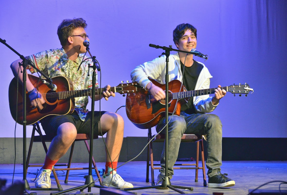 teen-boys-performing-guitar-duet-music-camp – Long Lake Camp For The Arts Two teen boys performing a guitar duet on stage after meeting at music camp and forming a creative friendship