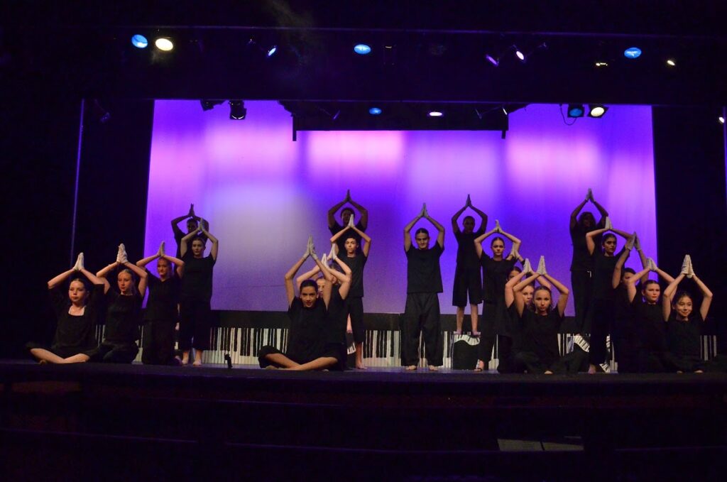 camper-stage-dance-collaboration – Long Lake Camp For The Arts Campers performing a synchronized dance sequence on stage with confidence