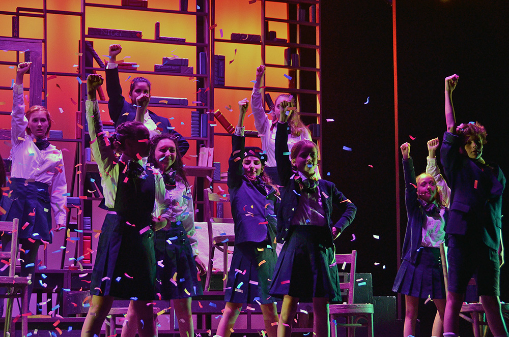 campers-dance-musical-confetti – Long Lake Camp For The Arts Campers performing a dance sequence from a musical theater show with confetti and lighting effects