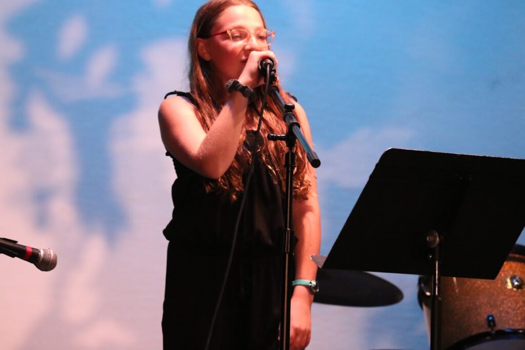 camper-confident-stage-performance – Long Lake Camp For The Arts Camper performing confidently on stage