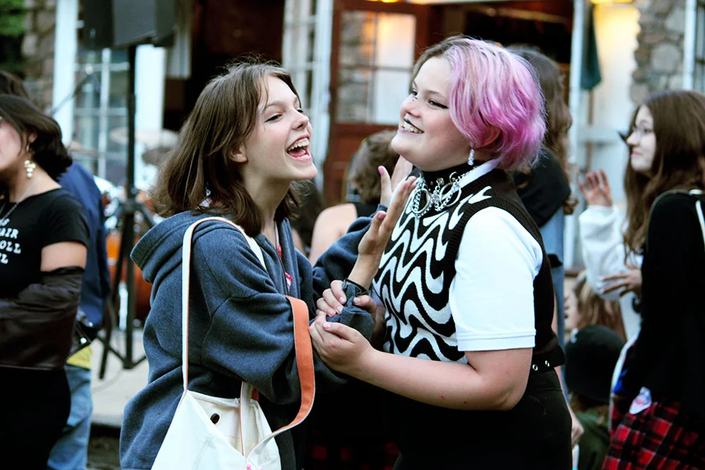 35-3 – Long Lake Camp For The Arts Teen campers laughing and enjoying themselves during a rock music.
