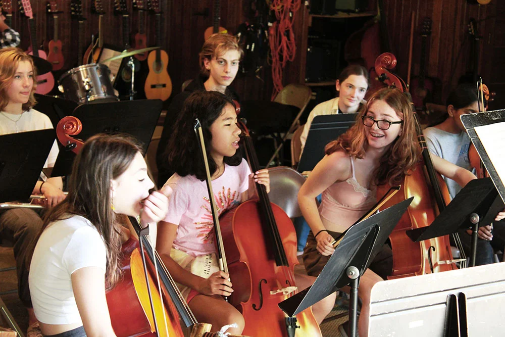 43-3 – Long Lake Camp For The Arts Campers learning to play instruments during a music camp