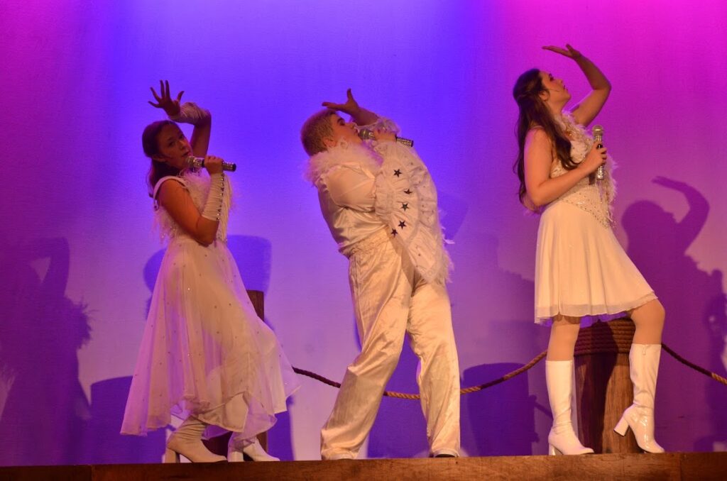 DSC_2857 – Long Lake Camp For The Arts Campers performing a choreographed dance sequence on stage while wearing coordinated costumes
