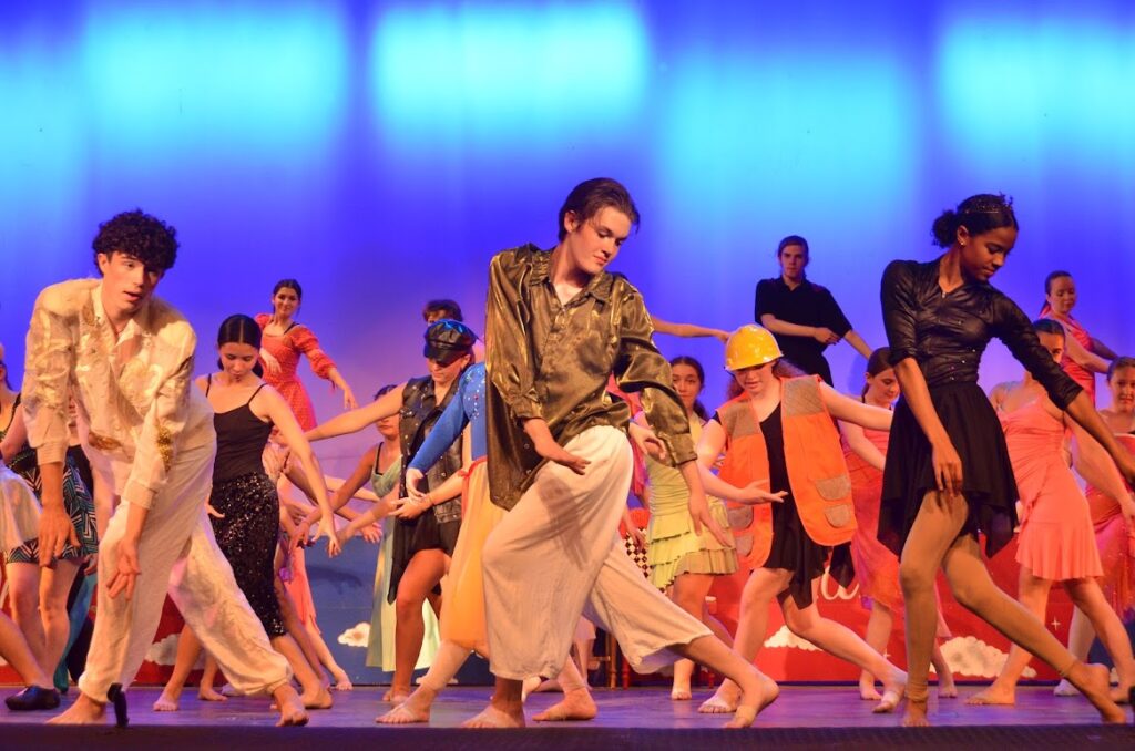 DSC_8307 – Long Lake Camp For The Arts Campers performing a synchronized dance ensemble on stage in costume during a show