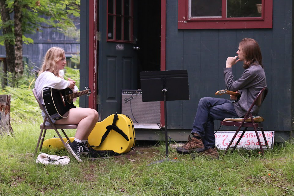Picture14 – Long Lake Camp For The Arts Teen musician practicing guitar under the supervision of a professional music instructor
