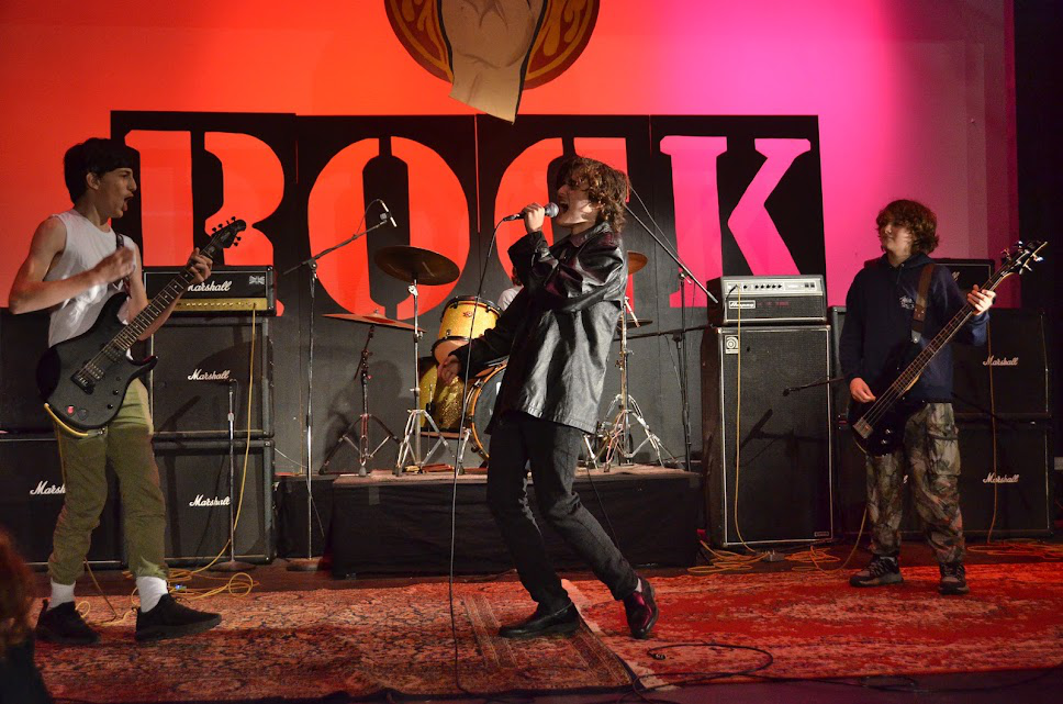 Picture20 – Long Lake Camp For The Arts Teen campers performing live music passionately on stage during a rock night concert