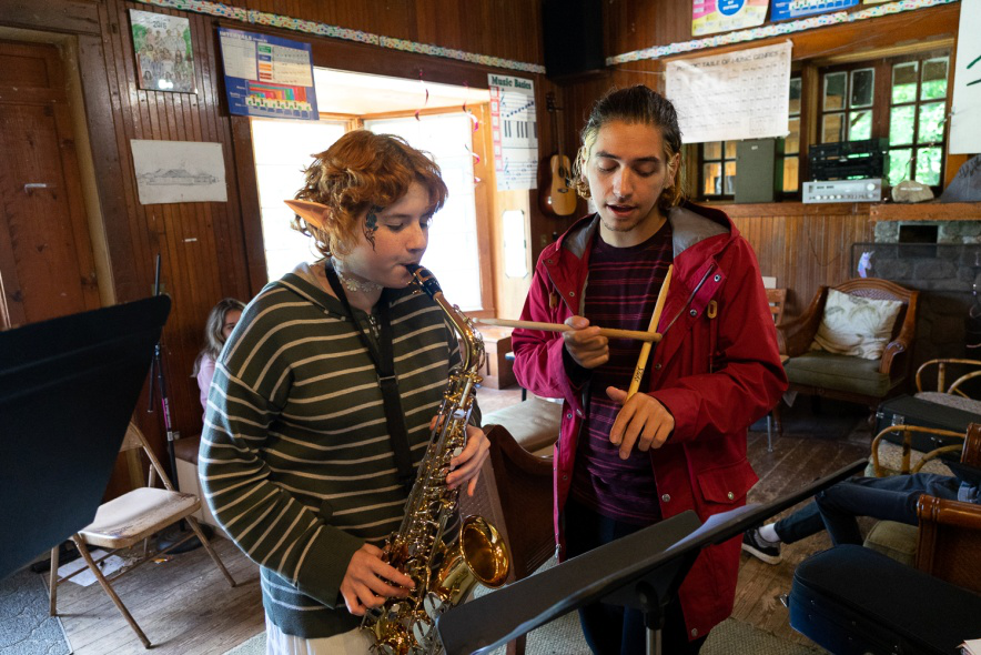 Picture100 – Long Lake Camp For The Arts Music instructor teaching campers how to play an instrument