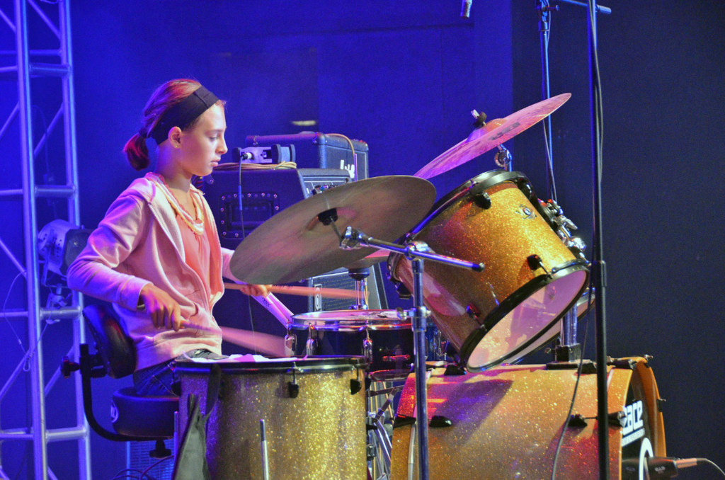 Picture52 – Long Lake Camp For The Arts A teenager performing on stage