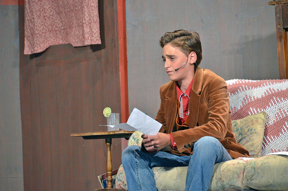 Picture85 – Long Lake Camp For The Arts A boy performing on stage