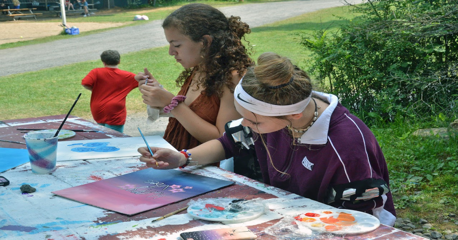 Picture26 – Long Lake Camp For The Arts Campers focused on painting during an art class at summer camp.