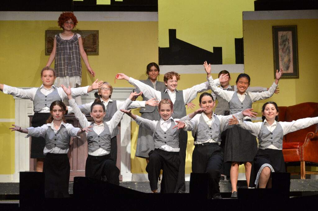 Picture32 – Long Lake Camp For The Arts Campers performing together on stage during a theater production.